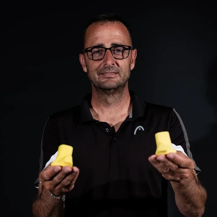 Marco Lucas, creator of Auro Grip, holding two Auro pieces